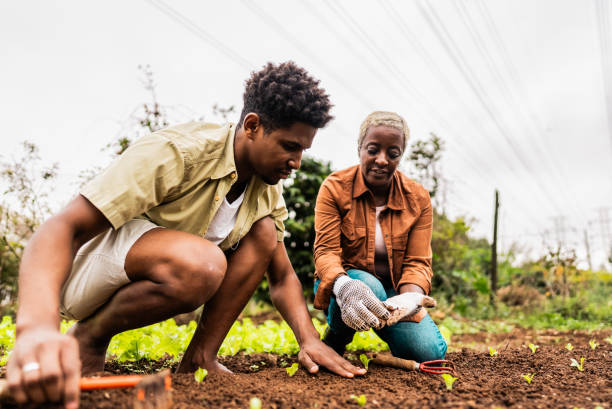 mother and son planting on community garden